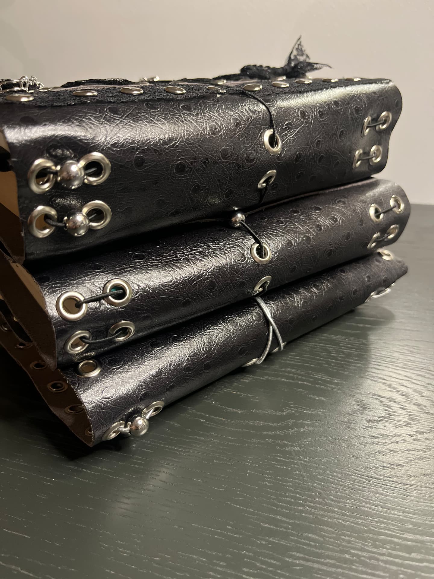 Stack of black studded leather journals
